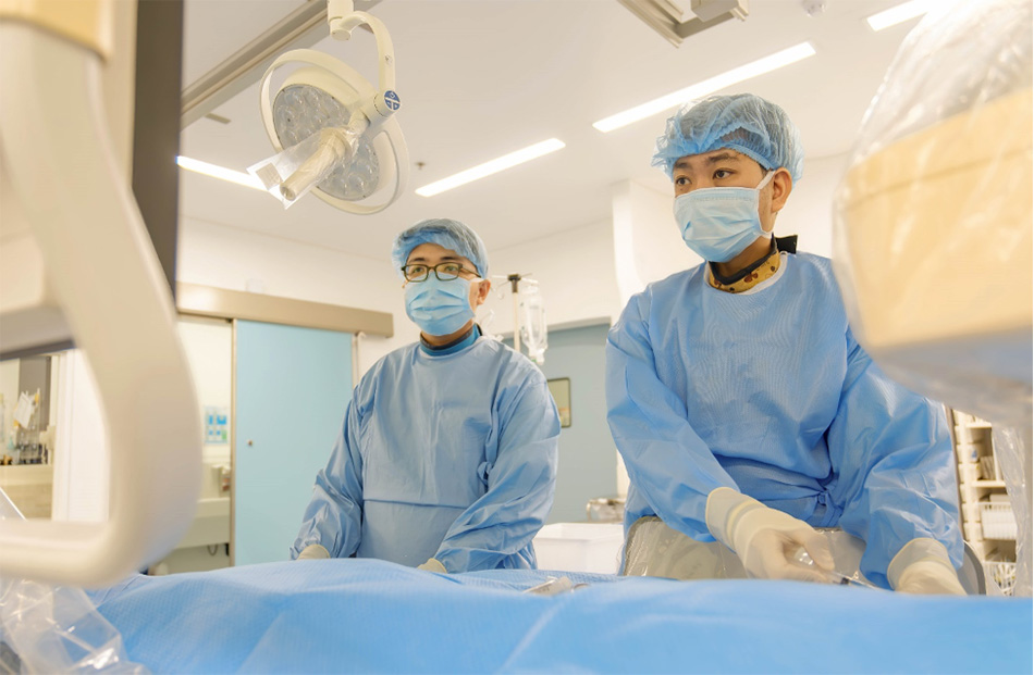 Dr Huynh Huu Danh (right) performing an endovascular procedure for a patient with a cerebral arteriovenous fistula